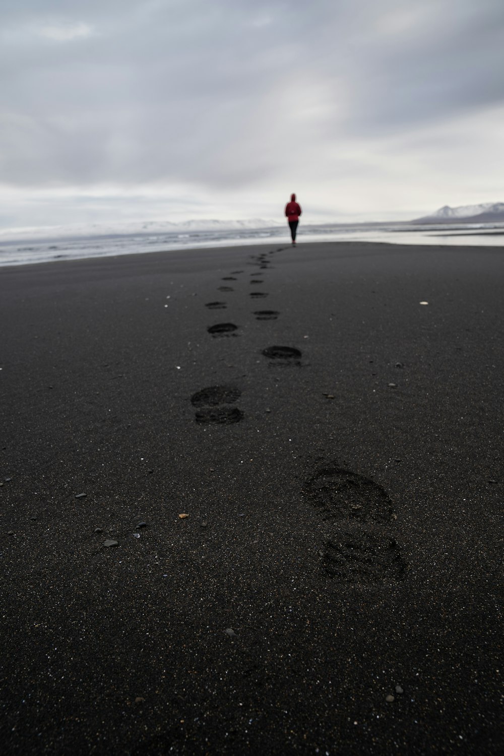 person walking on shoreline