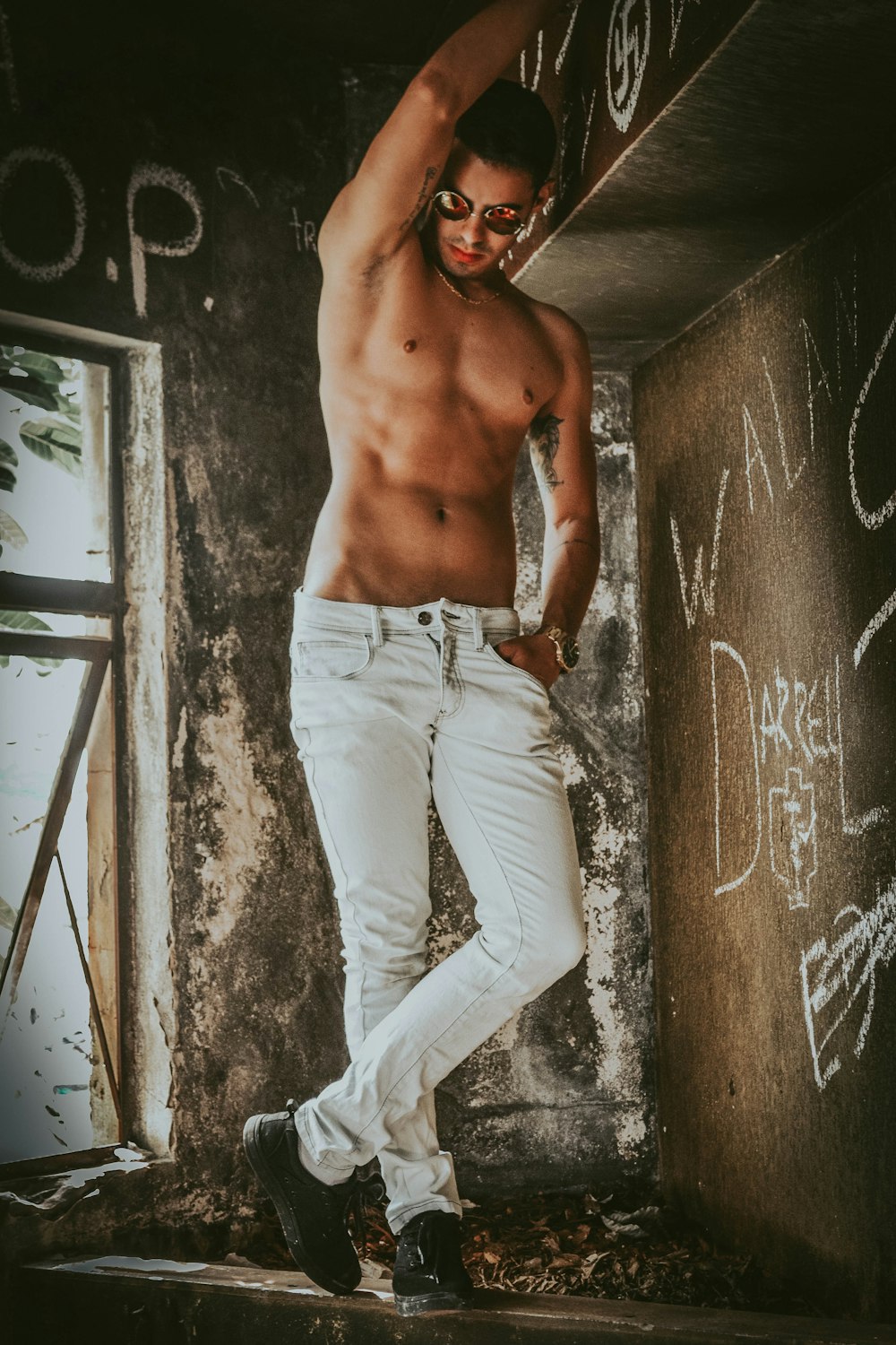 topless man wearing white jeans