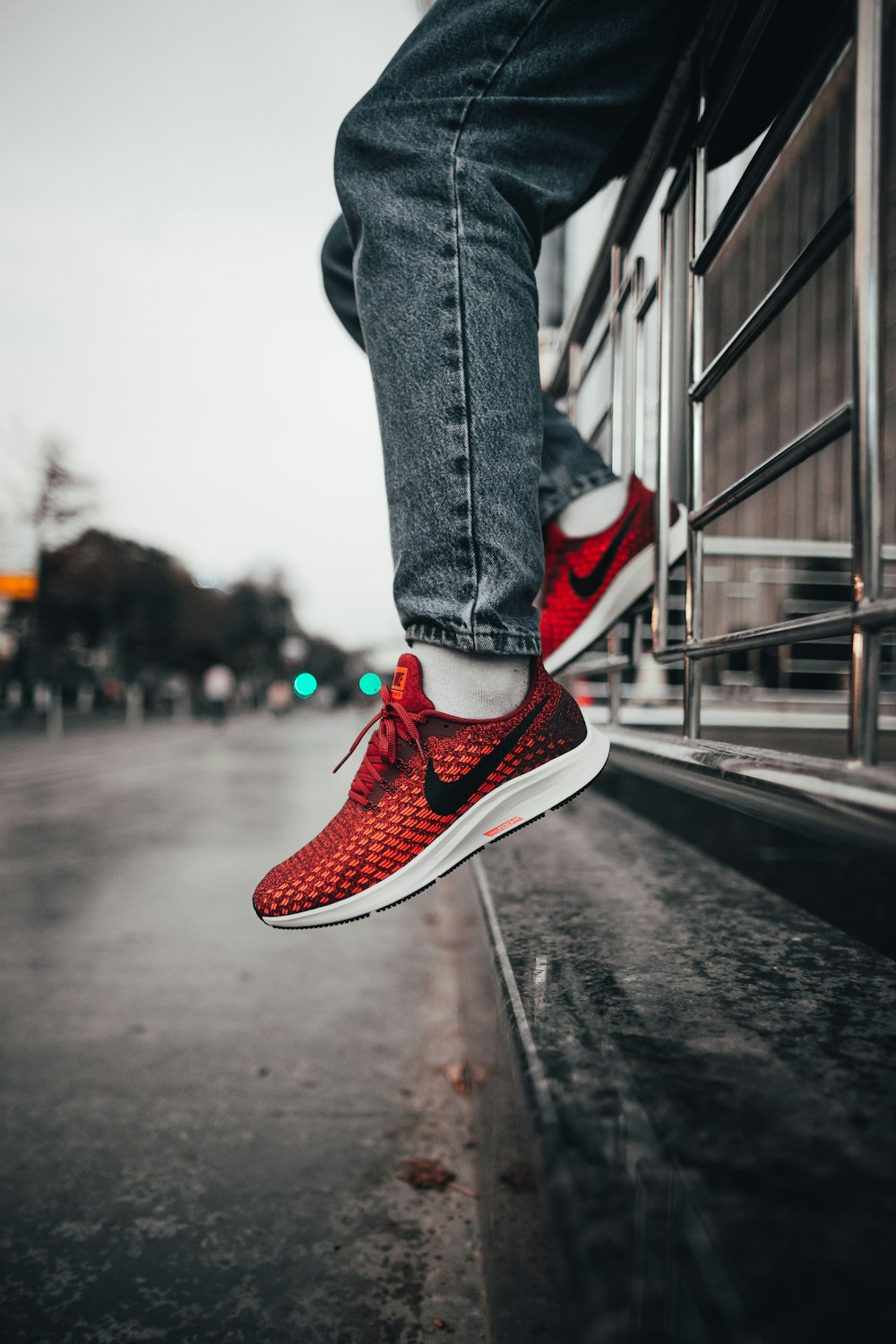 person wearing red Nike sneakers