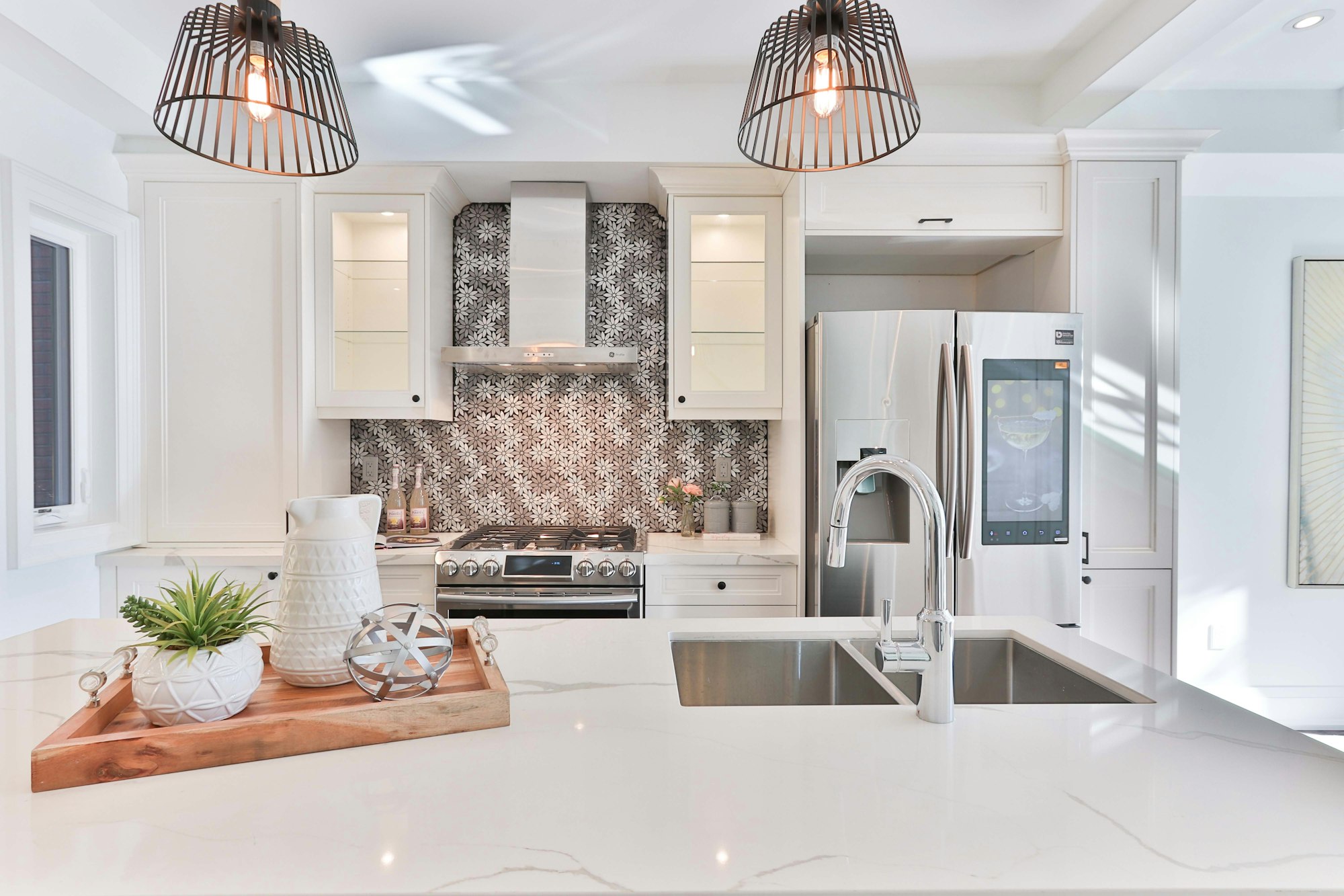 White kitchen with black and white mosaic backsplash
