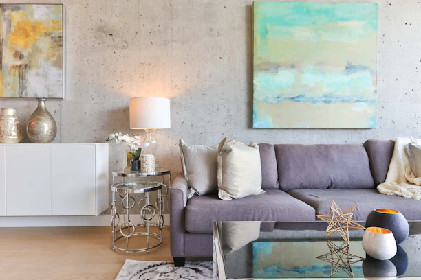 A beautifully painted modern living room with soft grey walls and gold accents.