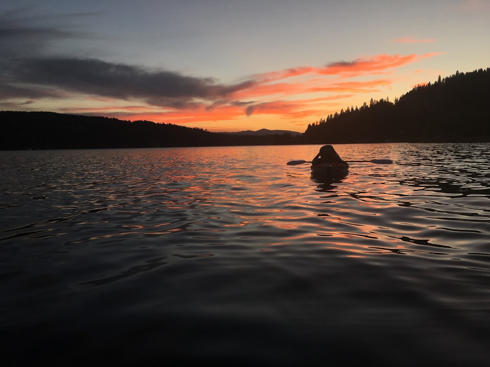 person in boat on body of water