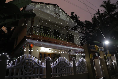 Elegant holiday light design sketch overlaying a Corpus Christi coastal home at dusk.