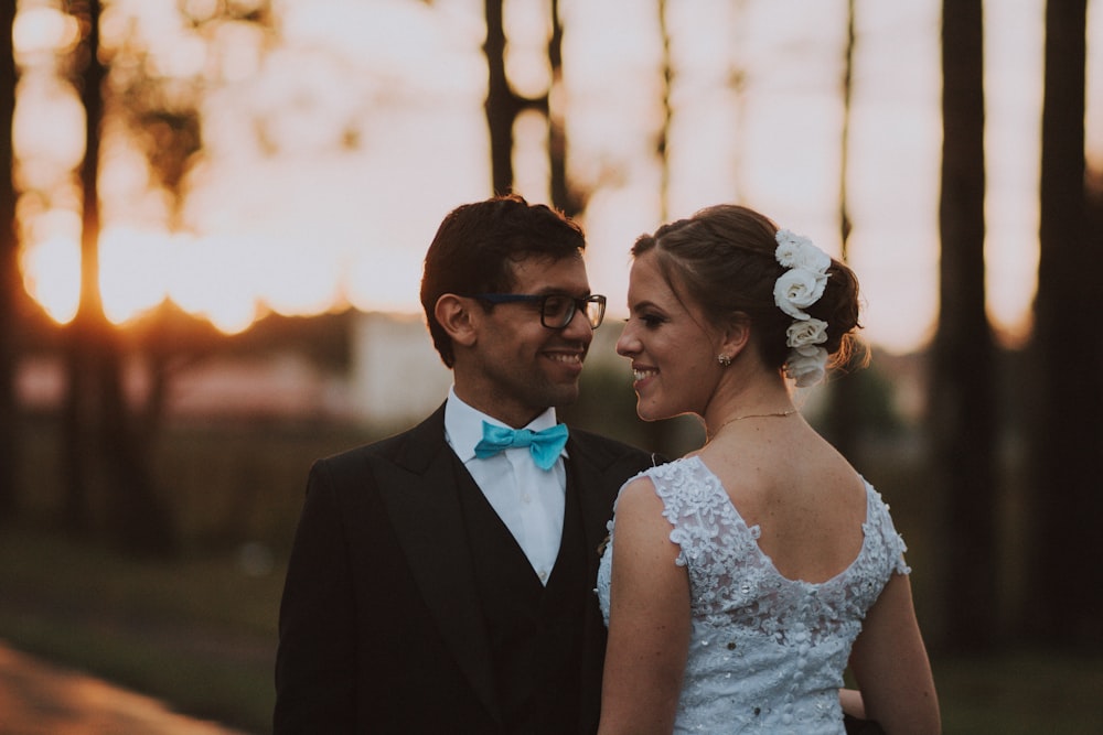 man and women smiling near trees