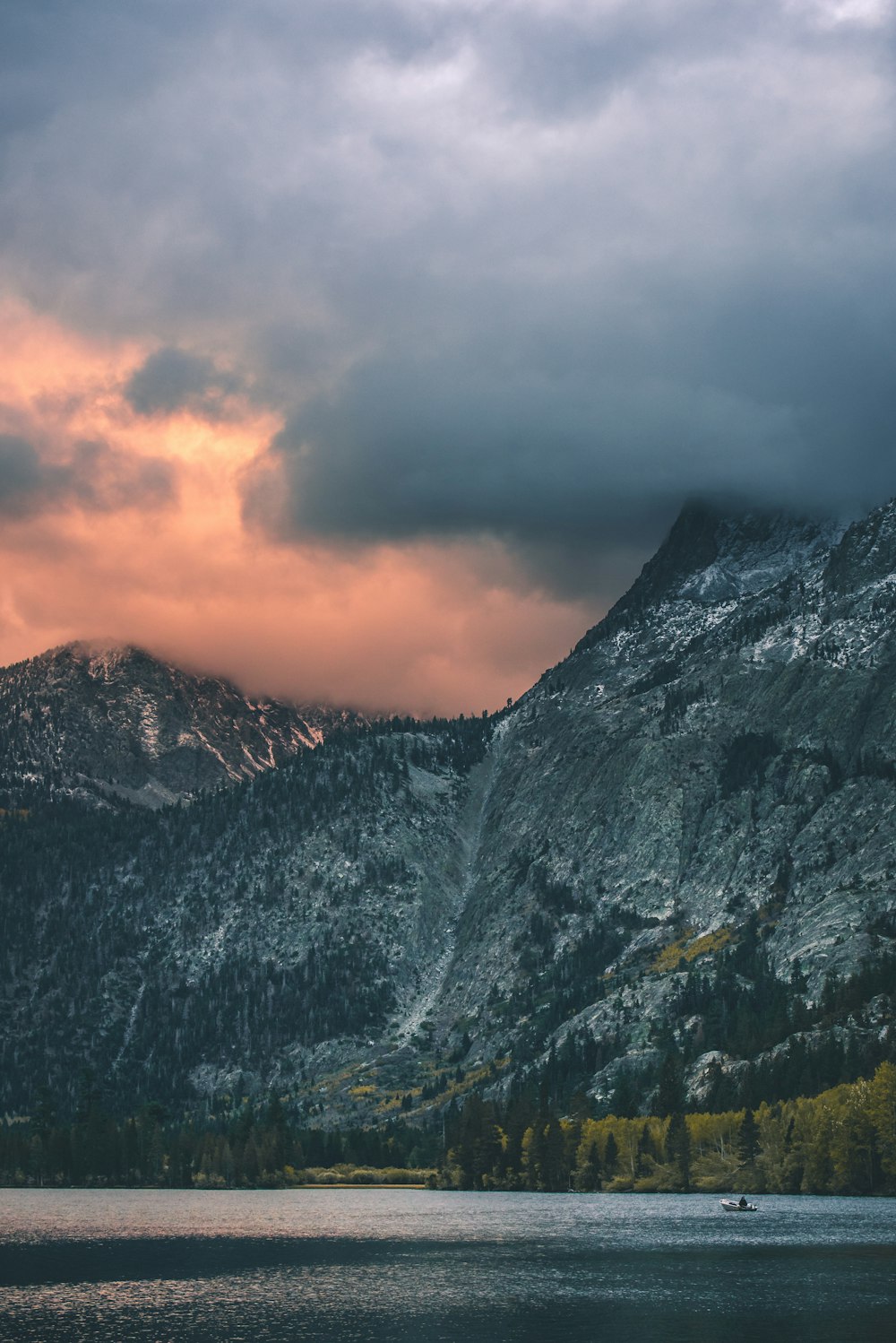 white clouds covering grey mountains