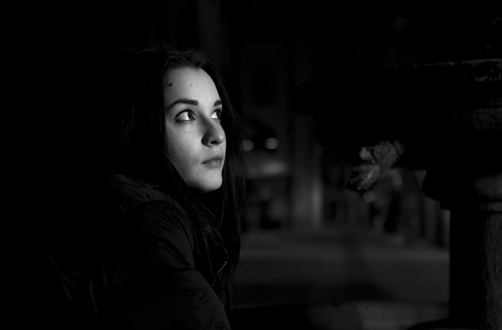 woman in black shirt looking upward