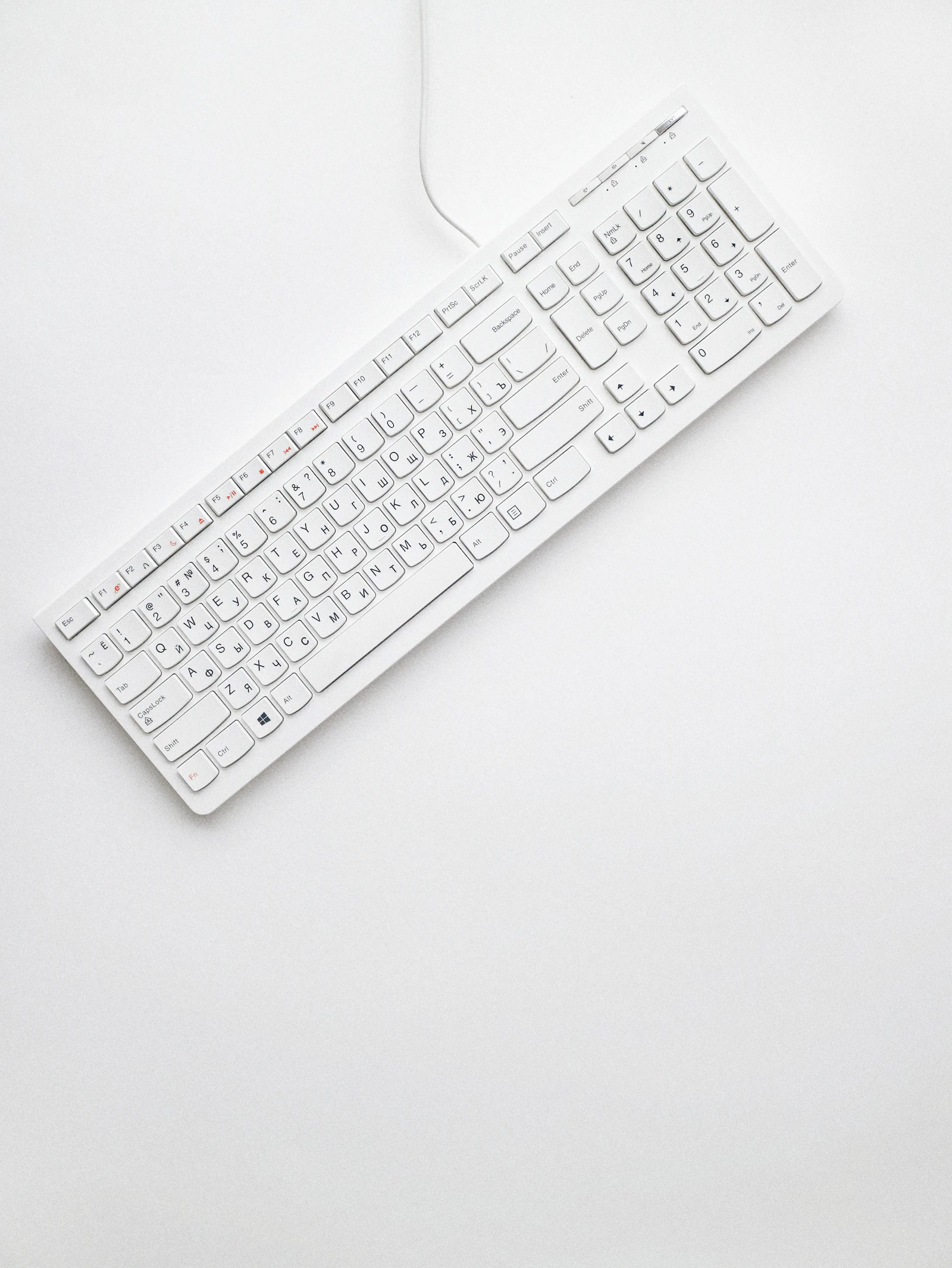 Compact ergonomic keyboard and mouse arranged on a small desk