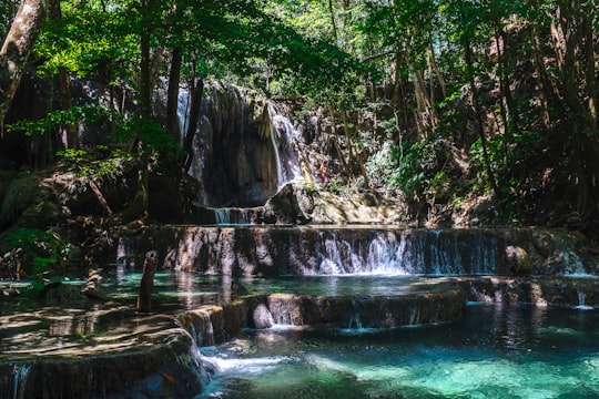 landscape photo of waterfalls during daytime in Sumbawa Indonesia