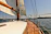 A calm sea view from the deck of a Bavaria46 sailboat under clear skies.