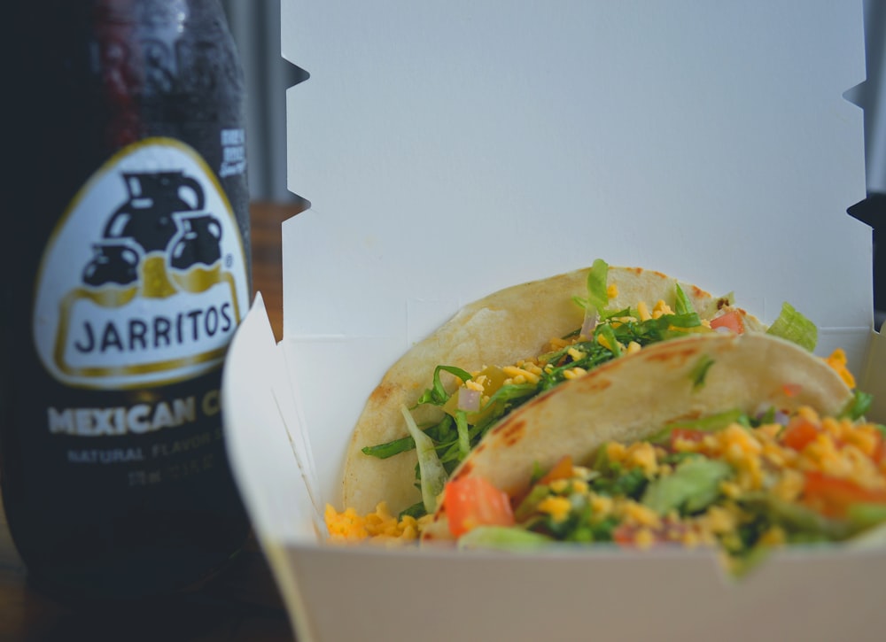 a taco and a bottle of beer on a table