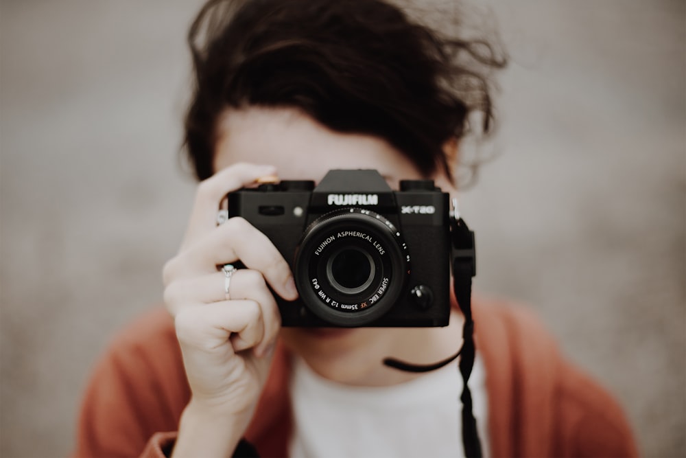 person taking photo using Fujifilm camera