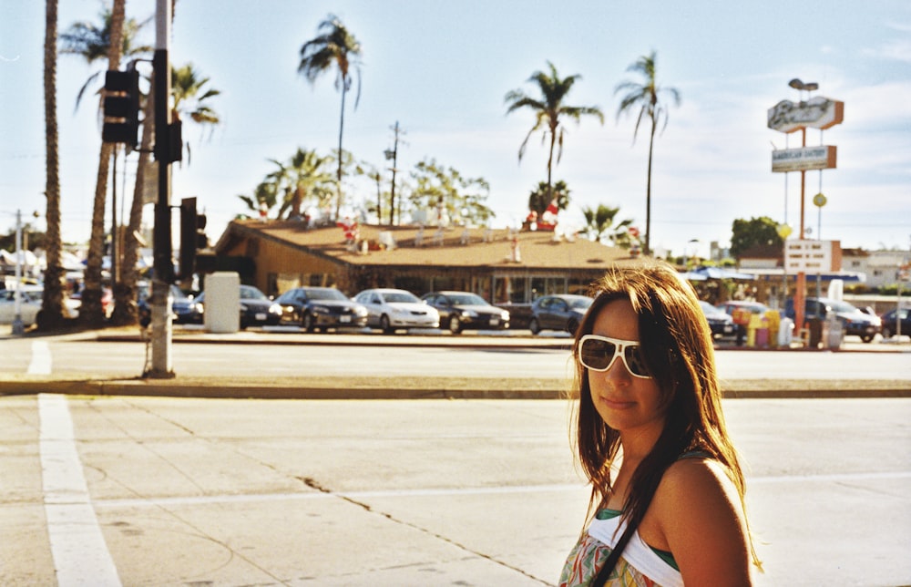 woman wearing sunglasses standing at the parking lot