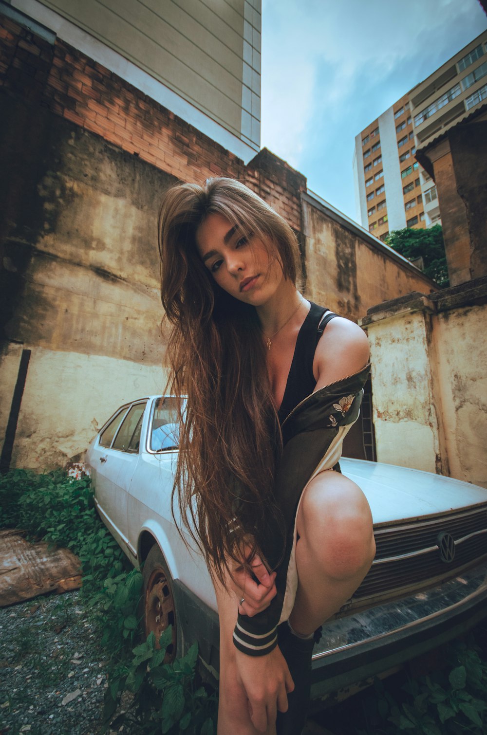 woman in black jacket sitting on white vehicle