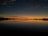 A serene image of a tranquil lake at sunset.