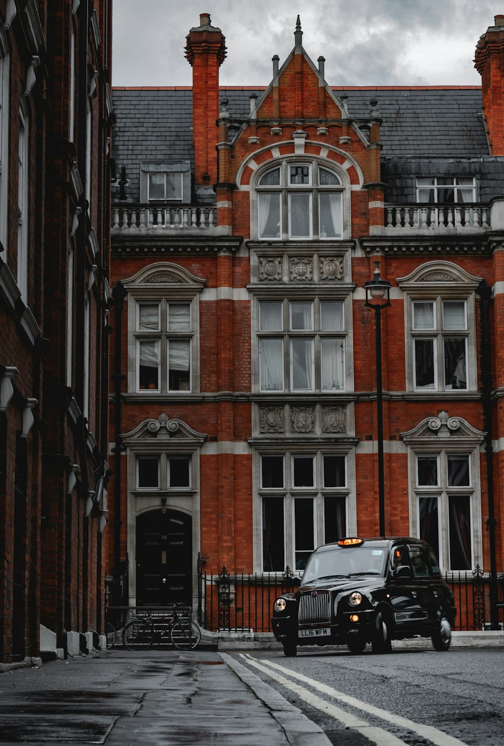 black car near brown concrete building during daytime