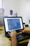 person using black laptop computer