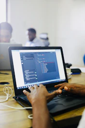 person using black laptop computer