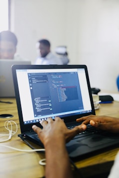 person using black laptop computer