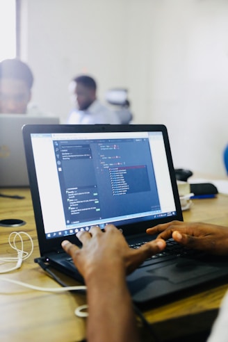 person using black laptop computer