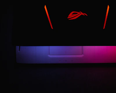 Close-up of the esportsclick logo glowing on a dark background with subtle blue and red accents.