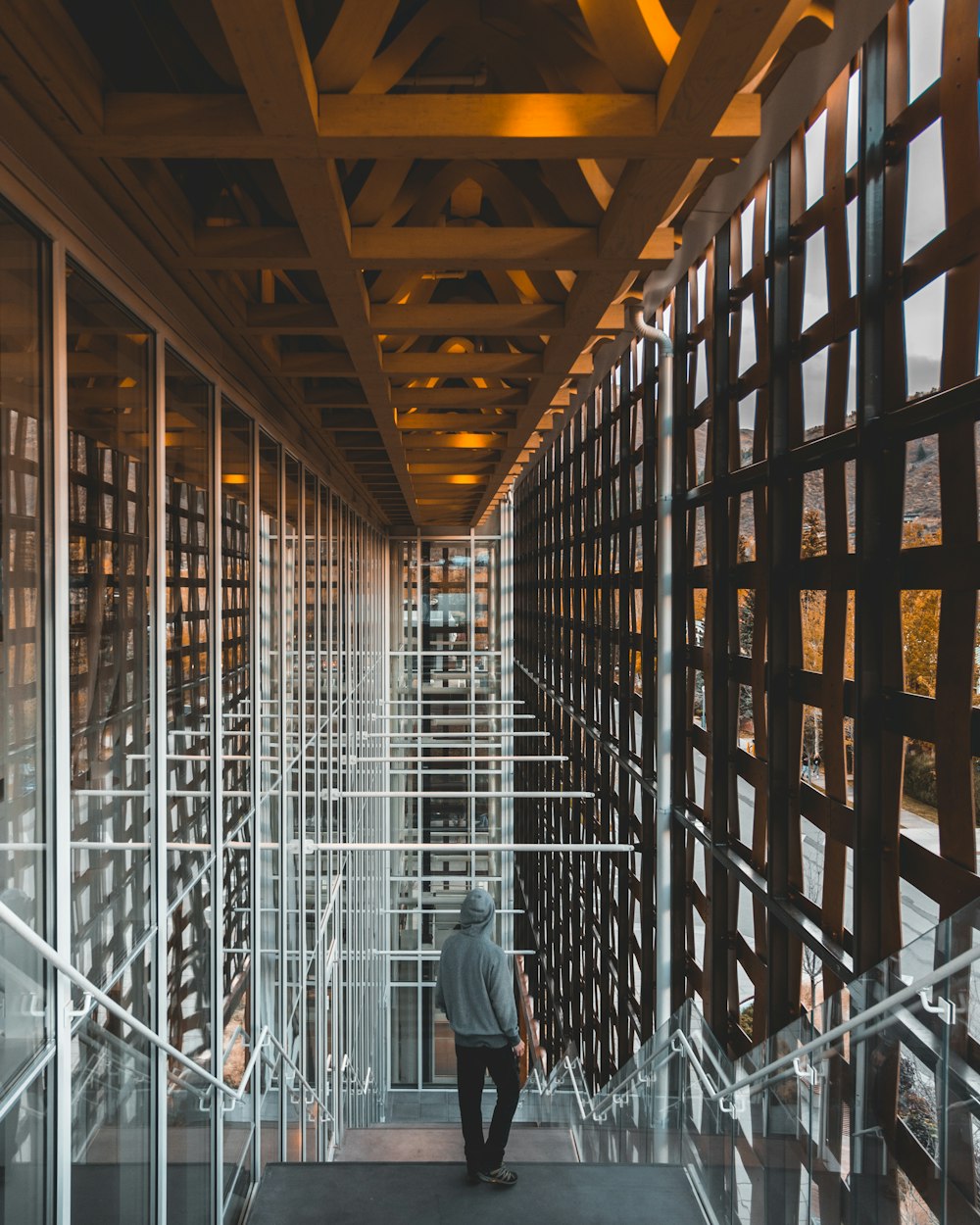 man standing at brown and gray metal structure