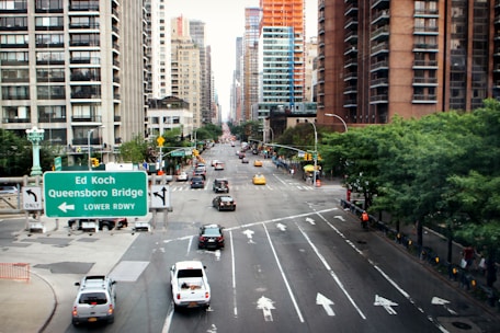 Photo of a Queens neighborhood with construction and city buildings in the background.