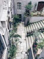 Charming courtyard garden with cobblestone paths and vintage lanterns, evoking old-world charm.