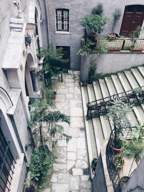 Charming courtyard garden with cobblestone paths and vintage lanterns, evoking old-world charm.