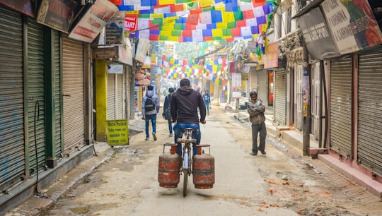 man riding bike with two gas cylinders in Thamel Nepal
