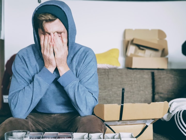 Man stressed with head in his hands.