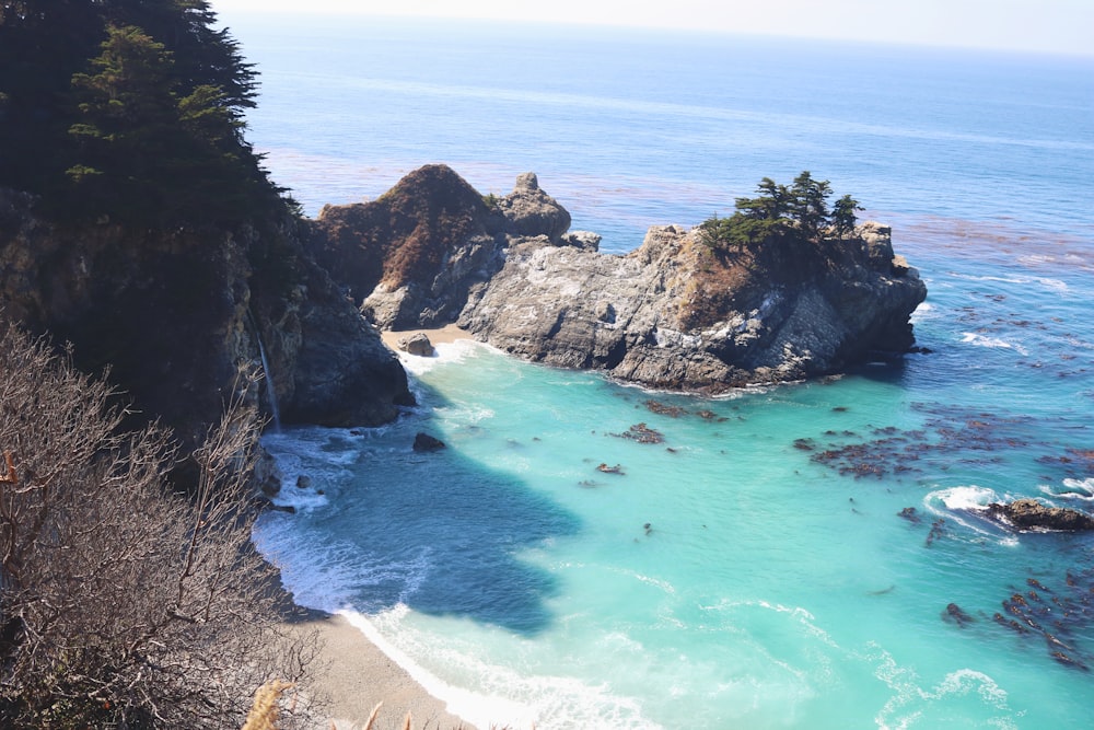 calm body of water near cliff