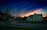 A tasteful, dark-toned photo of a well-maintained residential property at dusk.