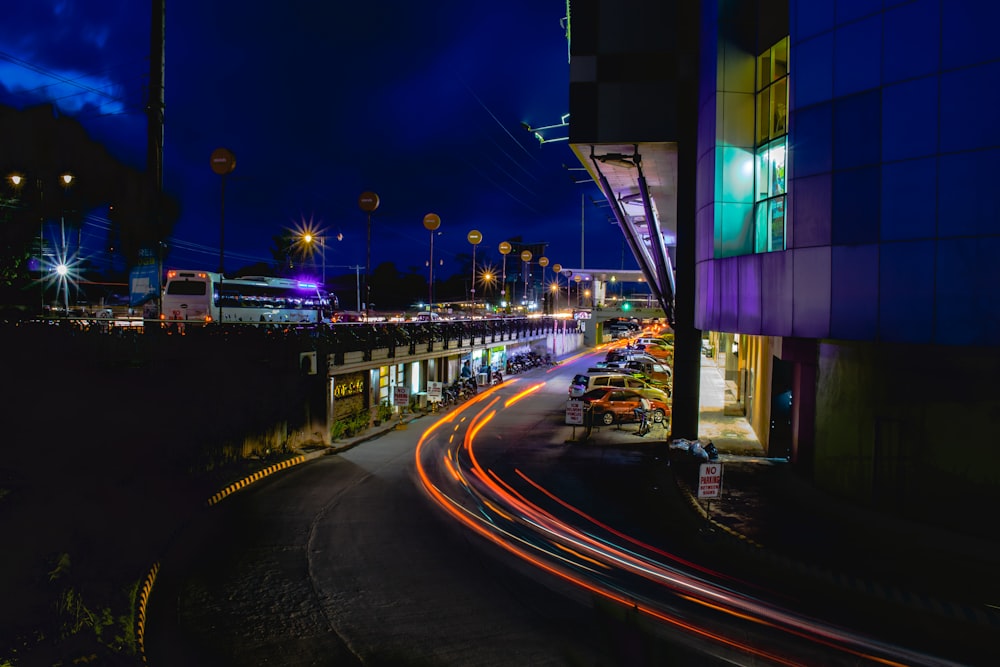 black and blue concrete building beside road during night time