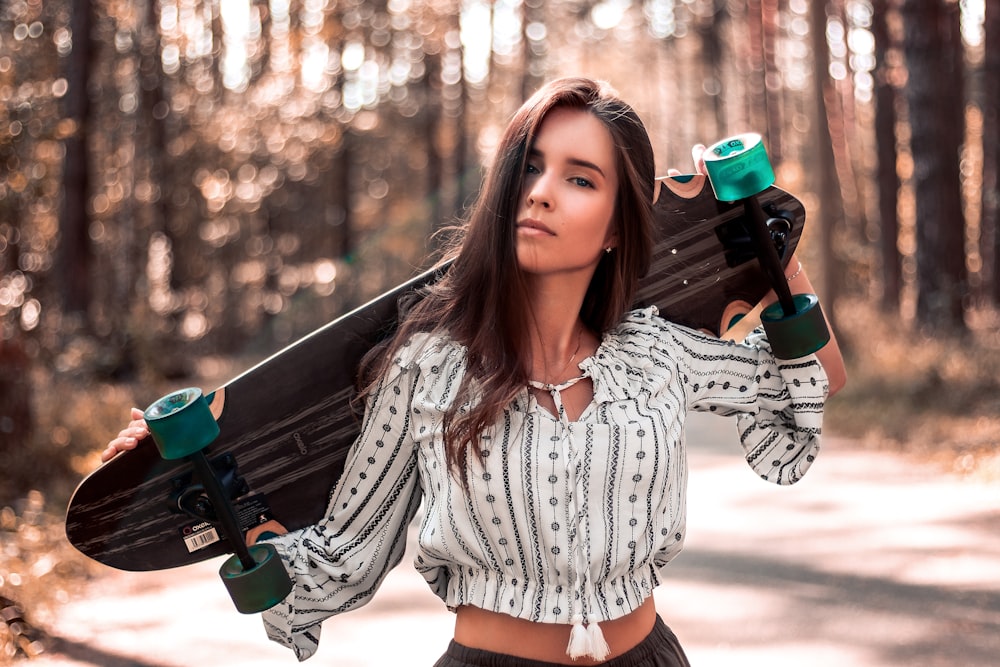 woman carrying skateboard on back