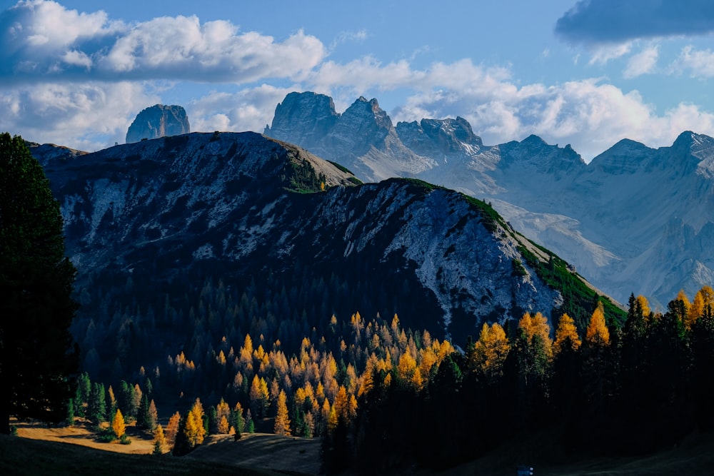 black and gray rocky mountain under white and blue cloudy sky