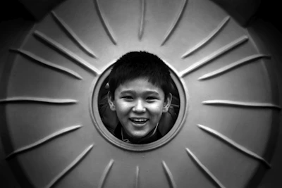Child smiling while engaging in a structured play activity as part of ABA therapy.