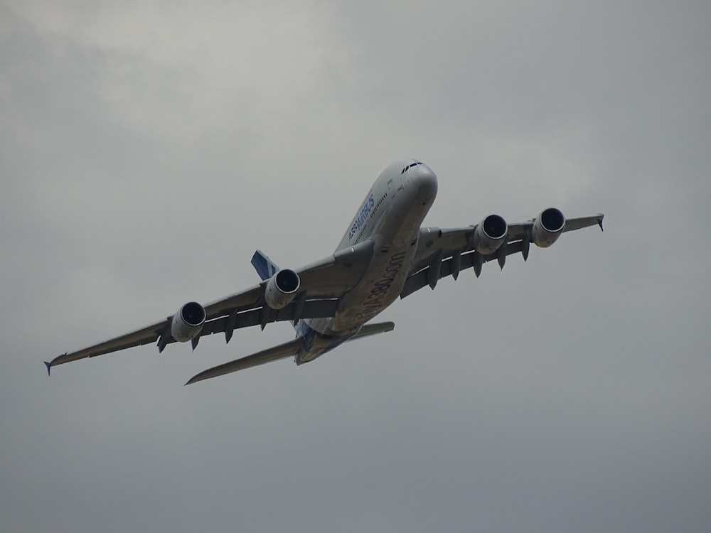 white and blue airliner in sky