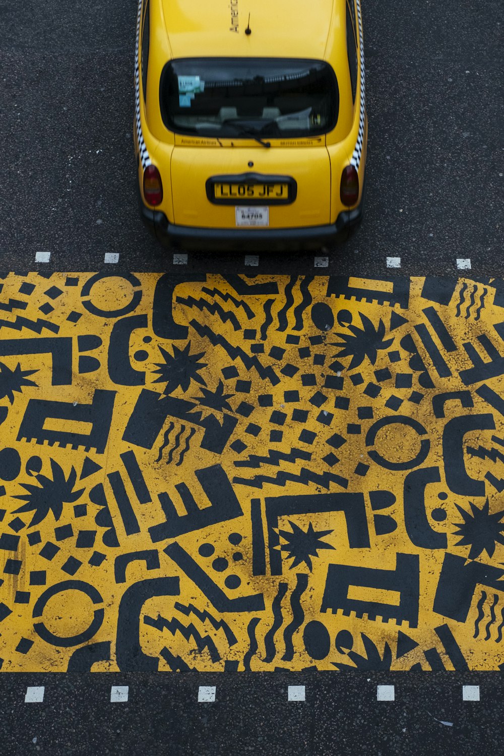 yellow vehicle parked at road during daytime