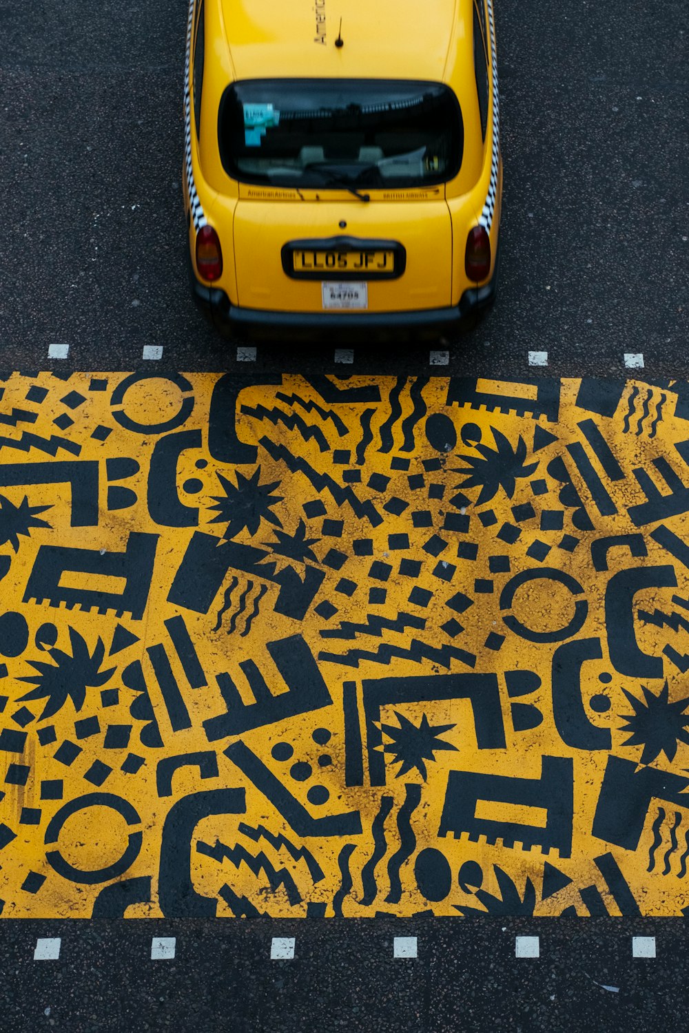 yellow vehicle parked at road during daytime