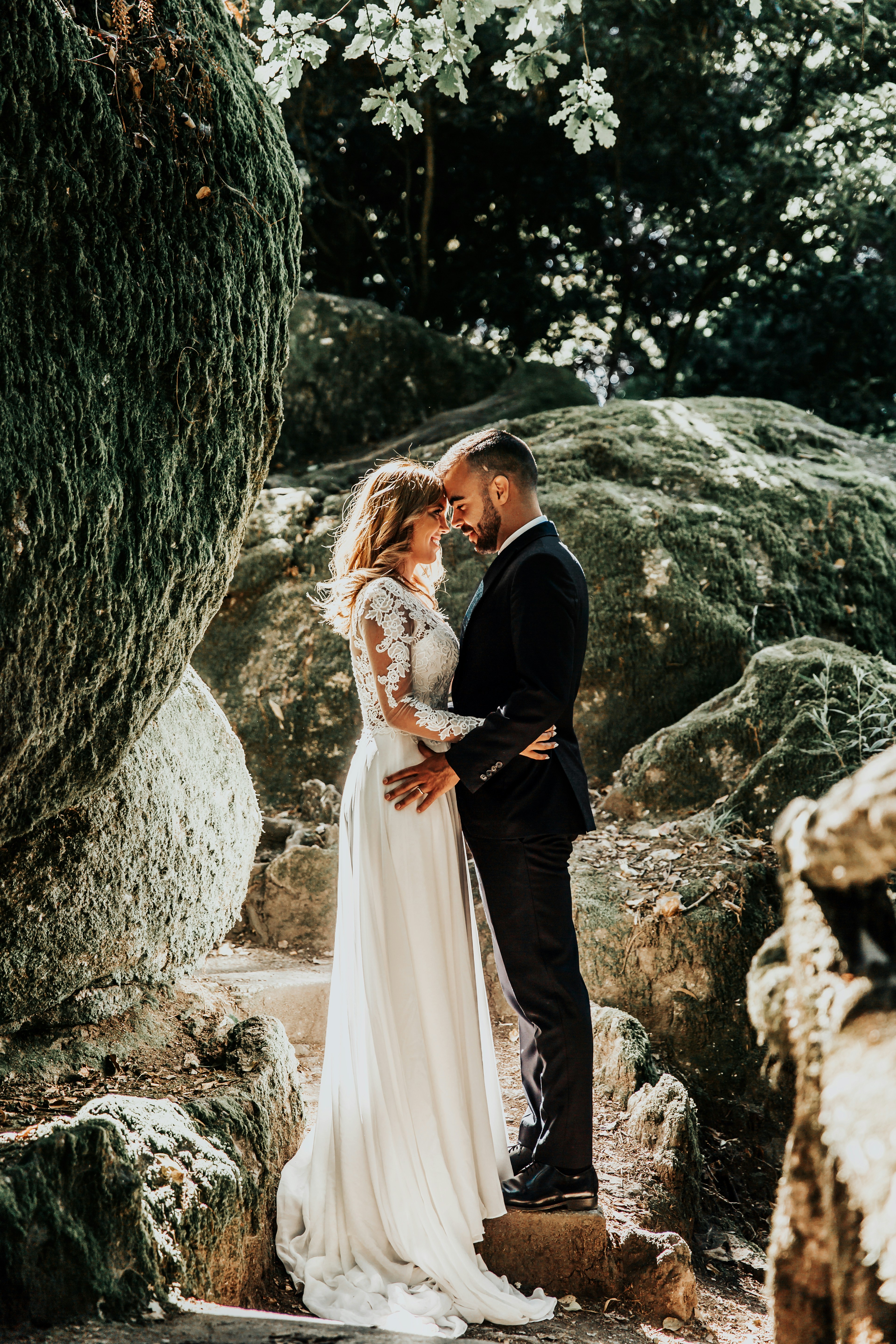 woman facing man standing on gray rock