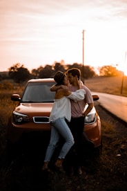 woman and man standing in front of vehicle