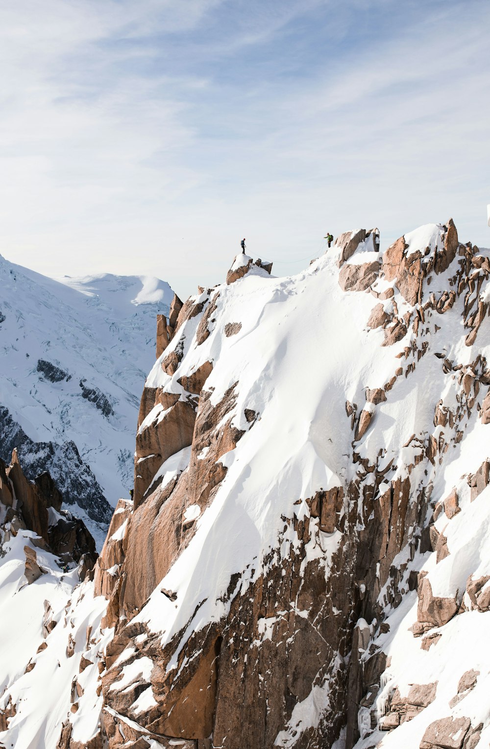 rock mountain covered by snow