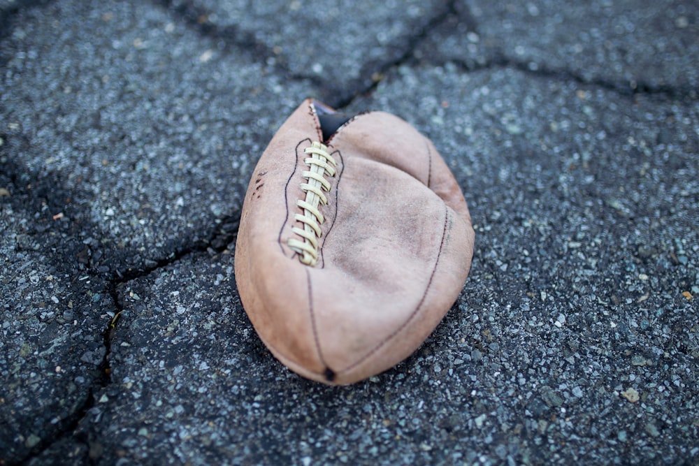 brown leather football on floor