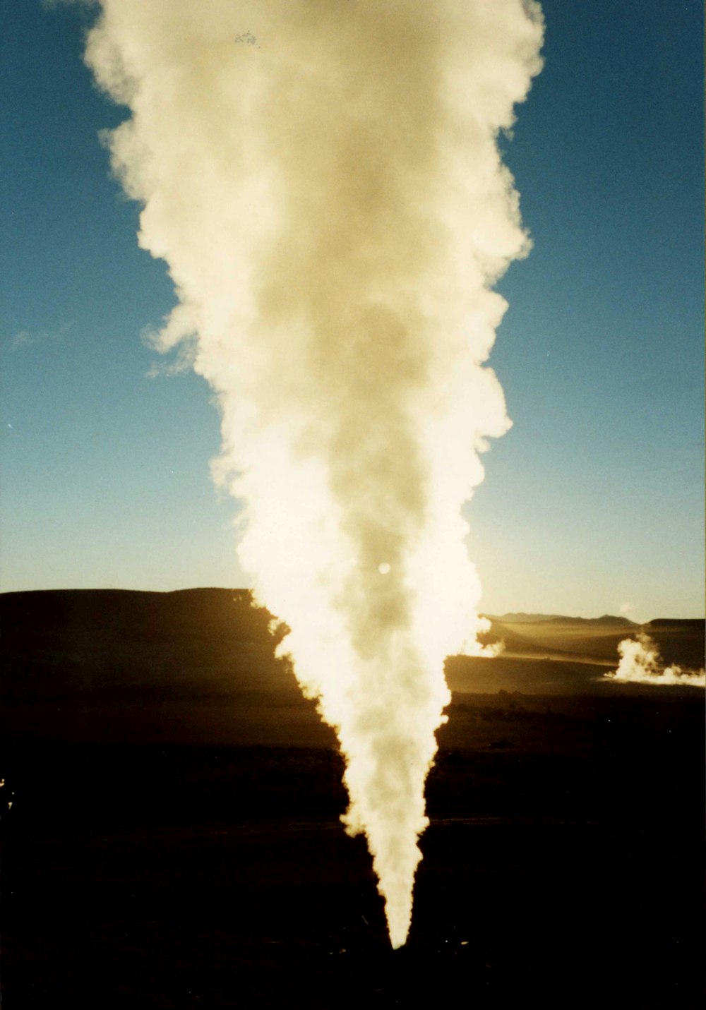 white smoke under clear blue sky