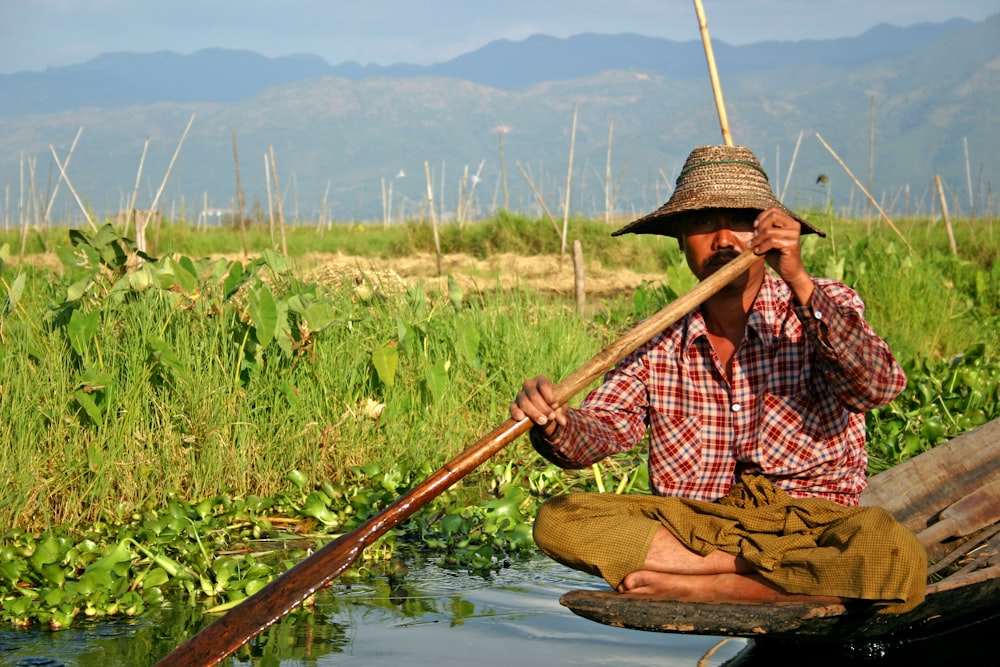 man riding brown boat