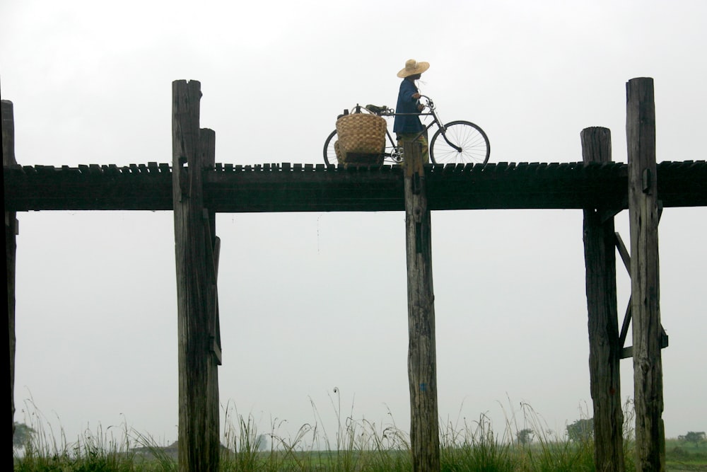 person with bike on bridge