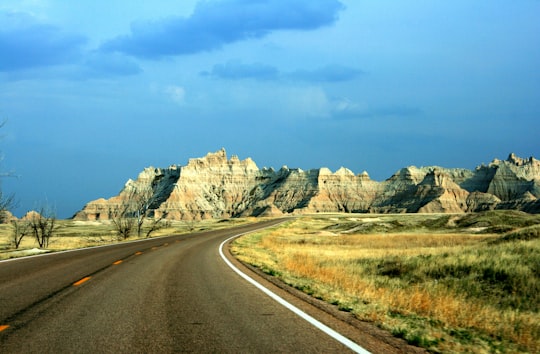 brown mountains near road during daytime in Badlands National Park United States