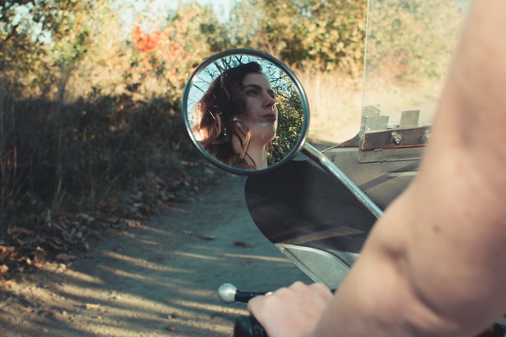 woman riding motorcycle on road