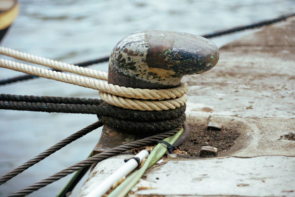 Side view of a dolphin structure featuring several robust marine bollards used for mooring large ships.