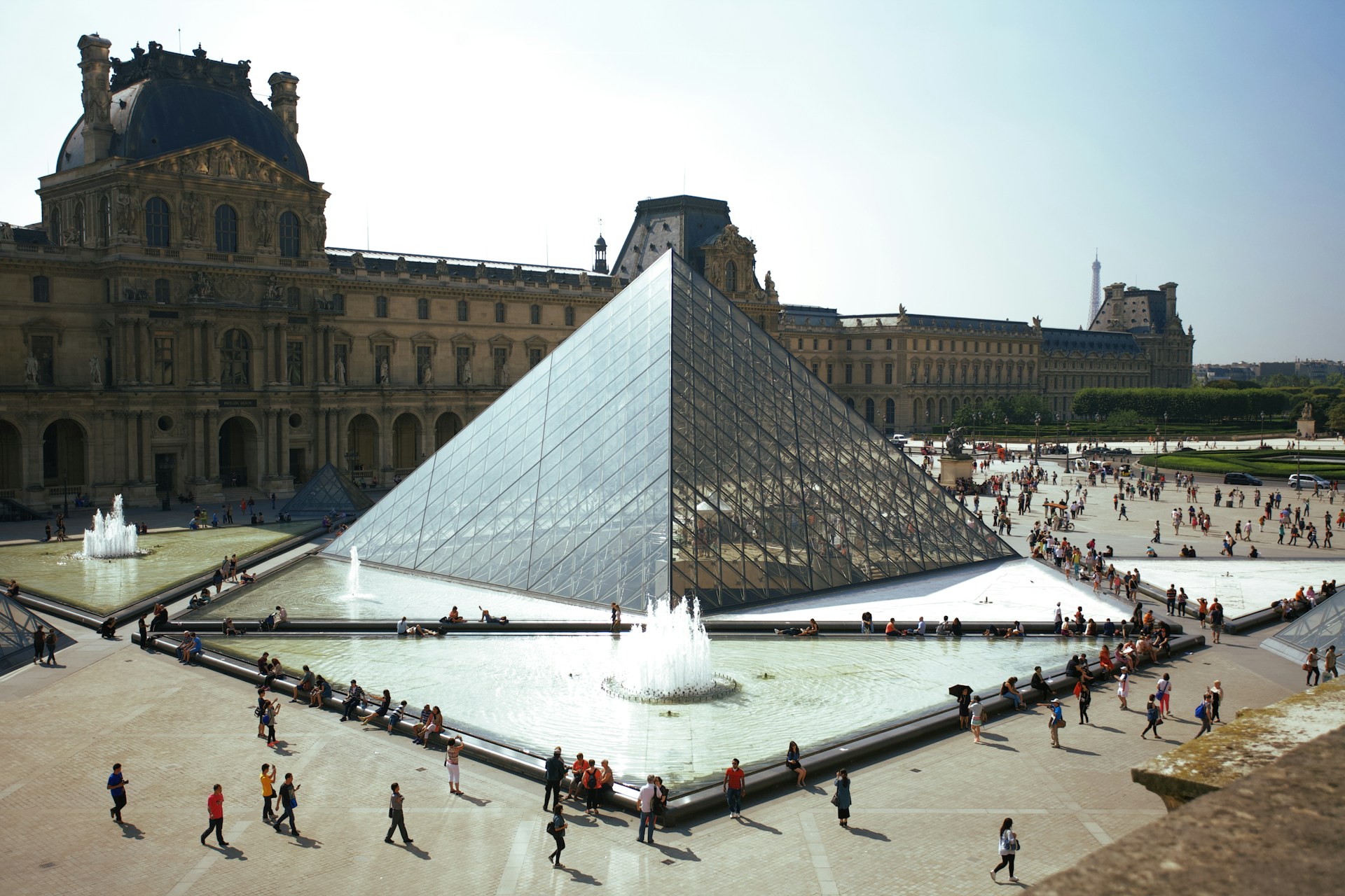 people walking around pyramid landmark